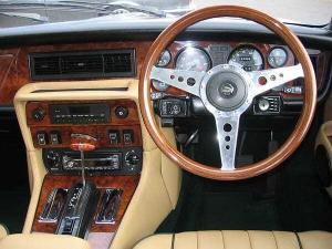 A 15” Mk9 steering wheel with drilled alloy spokes and plastic horn push, mounted on a Series 3 XJ